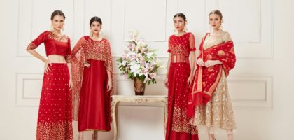 Four women showcasing luxurious Indian lehengas in a studio setting. Perfect blend of traditional elegance and modern style.
