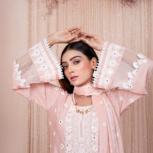 Portrait of a fashion model wearing an embroidered dress displaying elegance and style.