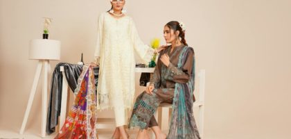 Two models in stylish Pakistani fashion attire captured in a studio setting.
