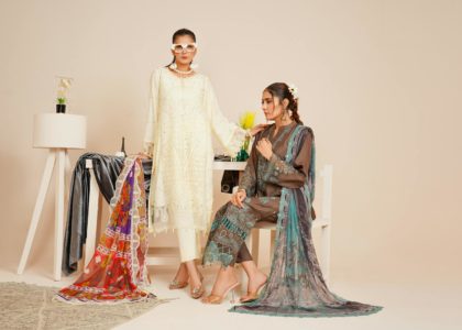 Two models in stylish Pakistani fashion attire captured in a studio setting.