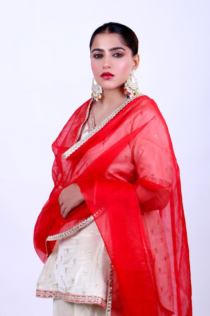 A woman wearing a red and white sari