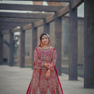 a woman in a red and gold wedding dress