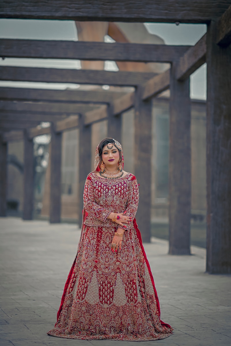 a woman in a red and gold wedding dress