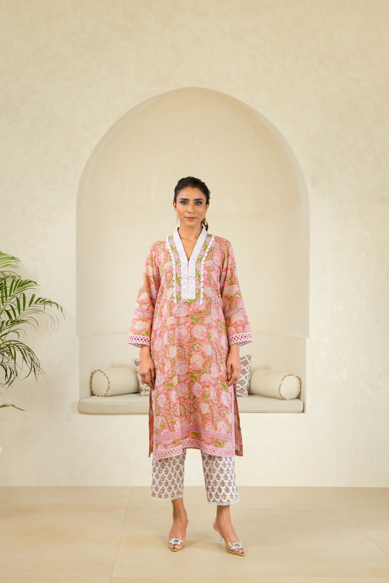 A woman standing in front of a white wall