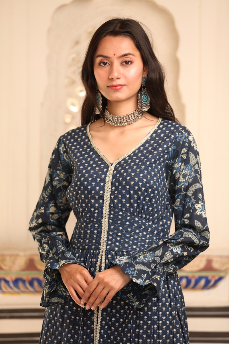 a woman wearing a blue and white dress