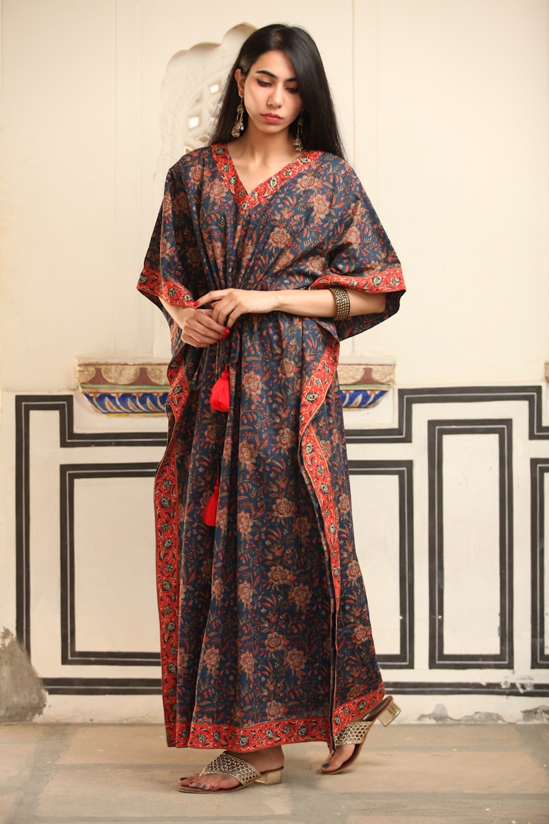 a woman standing in front of a white wall